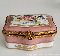 Front view closed showing floral design and clasp