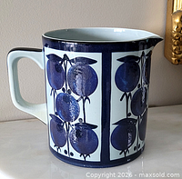Left-front view of Royal Copenhagen Tenera jug showing decorative panels and handle
