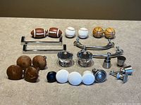 Assorted cabinet knobs and pulls arranged on surface