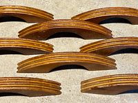Nine pulls laid flat showing routed layered edges and finish