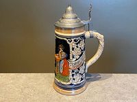 Full view of ceramic Marzi & Remy stein with pewter lid showing relief tavern scene and banner.