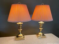 Both brass lamps with shades illuminated