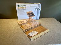 Knife block organizer, retail box and instruction leaflet displayed on table