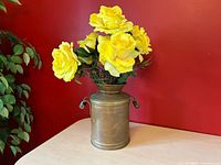 Front view of vase with faux yellow roses