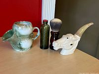 All four grooming collectibles grouped on tabletop