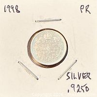 Full view of coin in holder with handwritten silver content