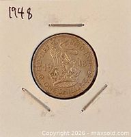 Reverse of 1948 one shilling coin showing lion atop crown design and date