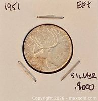 Reverse of 1951 Canadian 25 ¢ coin showing caribou and date