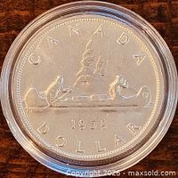 Reverse showing CANADA DOLLAR 1959 Voyageur design inside capsule