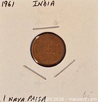 Coin in flip, obverse side visible with annotations