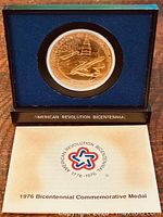 Medal in presentation case with brochure