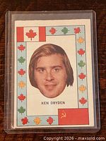 Front view showing Ken Dryden portrait and maple leaf border