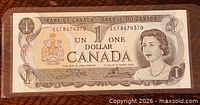 Obverse of 1973 $1 Canadian banknote showing portrait, serial number ECF8674370