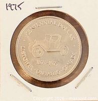 Obverse view in cardboard flip, showing full design and date