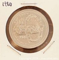 Obverse of coin in holder showing fur trade scene and 1980 date