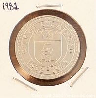 Obverse of 1982 Stratford Ontario trade dollar in flip