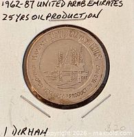 Obverse of coin with oil rig design and anniversary text