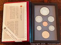 Closed clamshell case opened showing certificate and coin holder