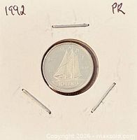 Coin in holder showing reverse with Bluenose schooner