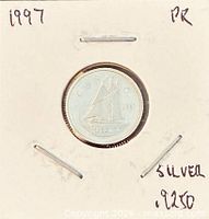 Coin in 2×2 holder, year and silver content noted