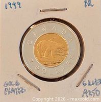Obverse and reverse views of coin in cardboard mount