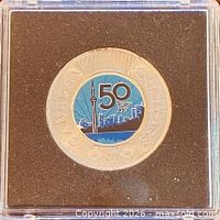Full coin in protective capsule against black foam insert