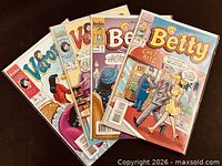 Front view showing five of the eight bagged Archie comics, Betty #149 visible