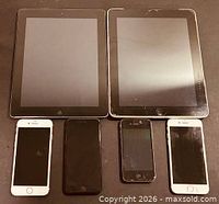 Six Apple devices arranged; verifying presence and visual condition