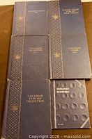 All six coin folders front covers visible