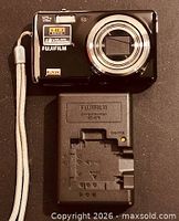 Front view of Fujifilm FinePix F80EXR camera with charger