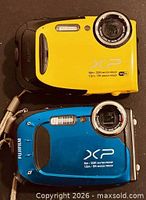 Front view of two Fujifilm XP cameras, yellow and blue