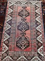 Full view of the Baluchi rug showing overall design and size