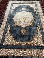 Full view of grey and gold Kashan rug showing overall design and borders