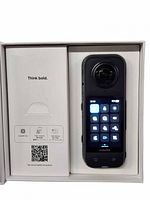 Front view of Insta360 X4 camera in original box showing touchscreen interface