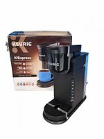 Keurig K-Express coffee maker beside its retail box