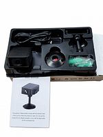 Camera in packaging with mount, cable, hardware and manual visible