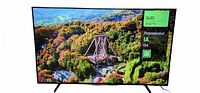 Front view of TV displaying landscape image and on-screen info indicating QLED 65Q7FA