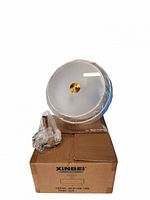 Light fixture wrapped in plastic with frosted glass diffuser and mounting hardware on original Xinbei box