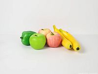 Full group view of two bananas, three apples, one bell pepper