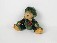 Front view of Boyds Bear "Taddley" seated in frog costume showing bow and heart patch