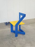 full view of chair angled right, showing asymmetrical frame and colors