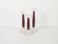 Full view of three staggered candle holders showing design and condition