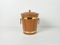 front view of teak ice bucket with lid showing brass bands and ring handles