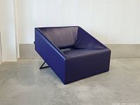 Front angled view of purple lounge chair showing upholstery and base