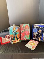 Group view of all five items: Captain Marvel doll, Wild Hearts Crew doll, LOL O.M.G. doll, Captain America purse, LOL inflatable ring