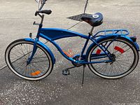 Right side view of entire blue Margaritaville beach cruiser showing whitewall tires, rack, chain guard, fenders