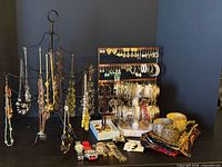 Overall view of both stands with necklaces, bracelets, earrings, watches, brooches and scarves displayed