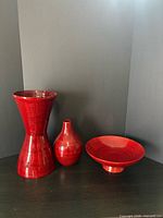 Front view of all three red bamboo decor pieces