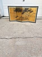 Full view of folded screen showing gold panels with bamboo scene