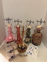 Group shot of all jewelry stands, necklaces, brooches, button covers